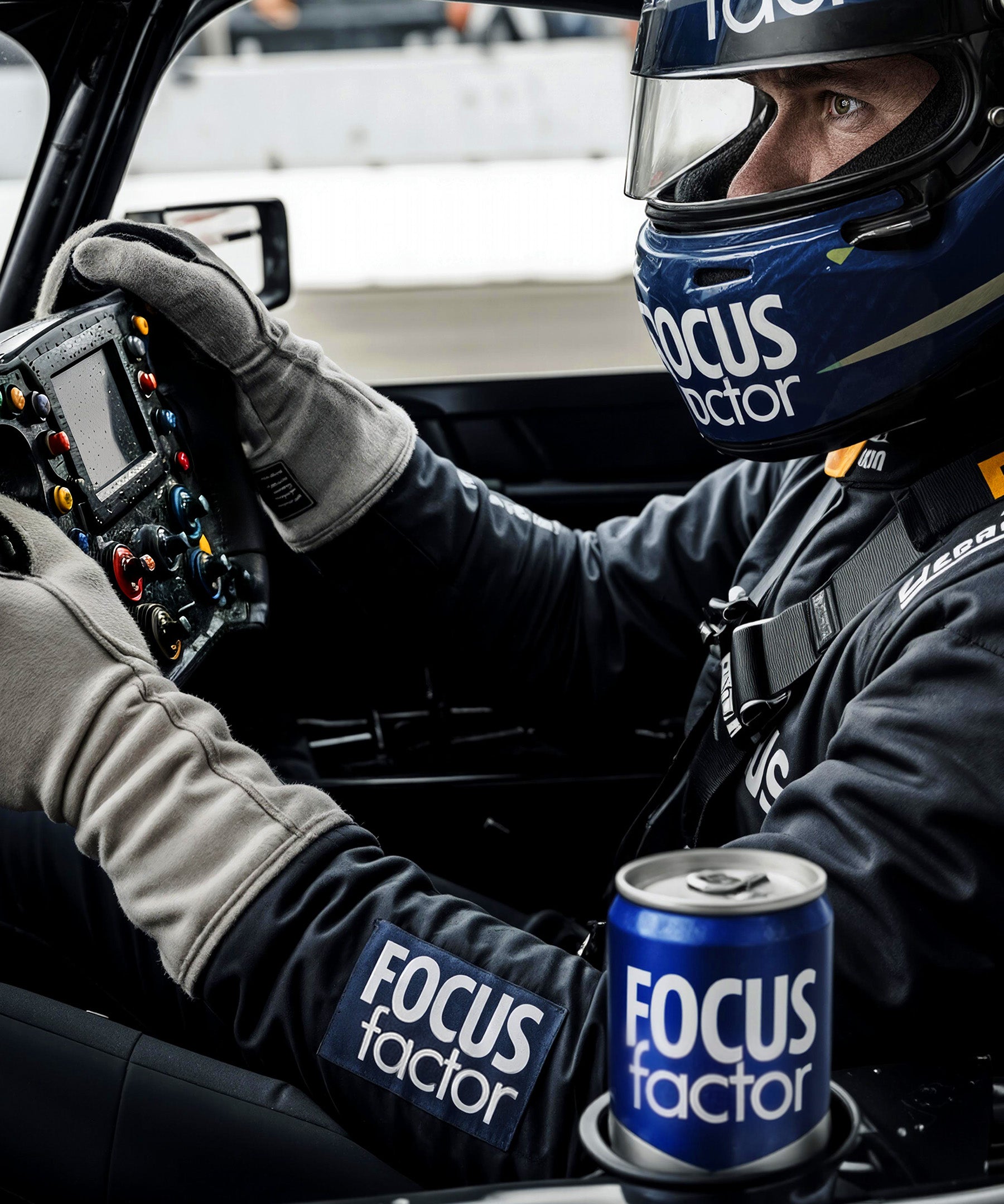 Racing driver in a car with 'Focus Factor' branding on helmet and can.